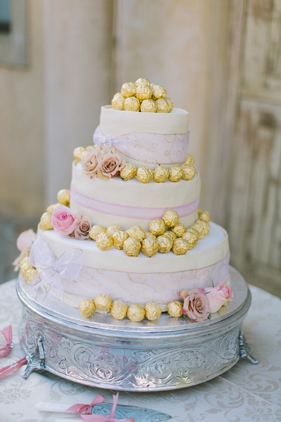 wedding cake topped with ferrero rocher chocolates