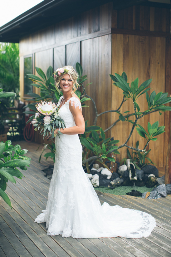 Happy bride in a lace wedding dress with a flower crown