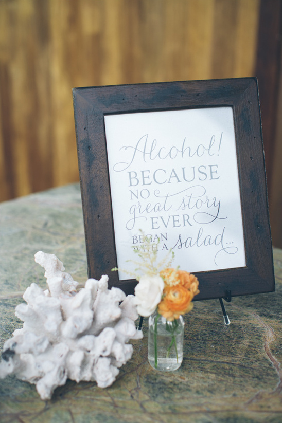Charming wedding sign with alcohol quote and floral arrangement