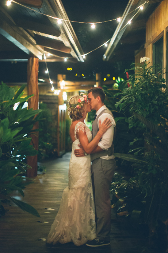 Bride and groom kissing during a night wedding ceremony