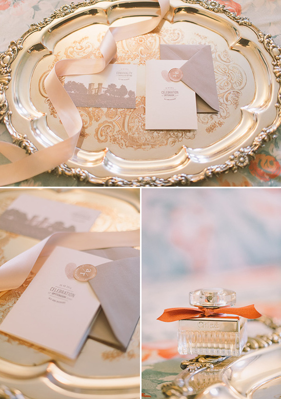 Elegant wedding invitations and perfume on silver tray