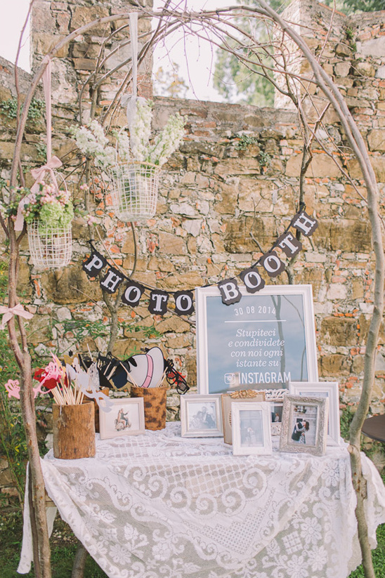 Rustic wedding photo booth with lace tablecloth frames