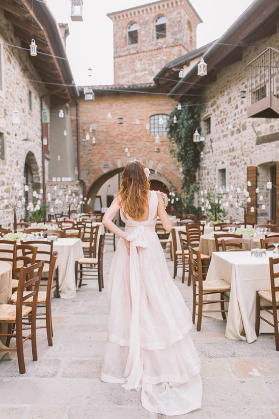 Bride in flowing gown at outdoor Italian wedding venue
