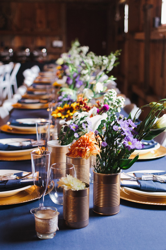 blue and gold table decor with tin can flower arrangements