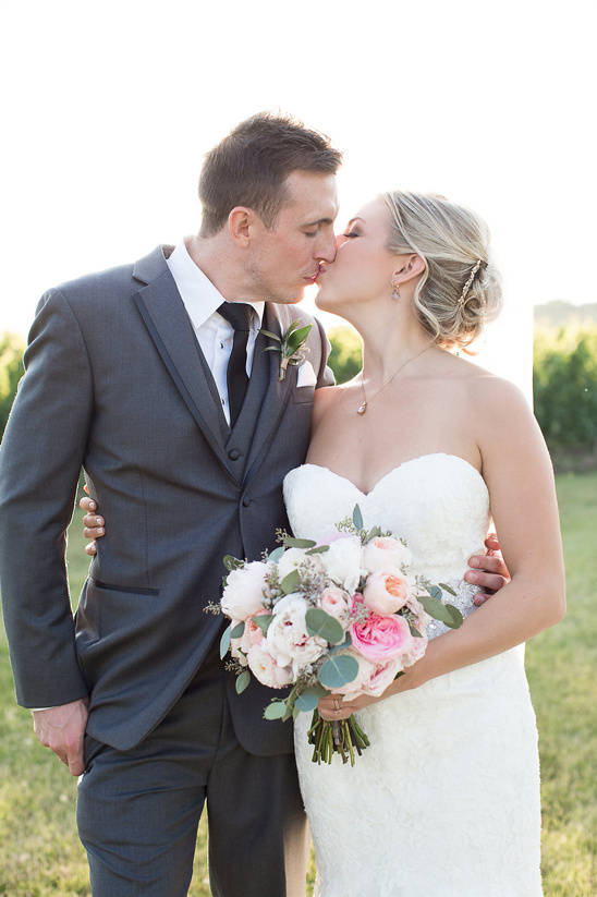 Newlyweds share a romantic kiss on their wedding day