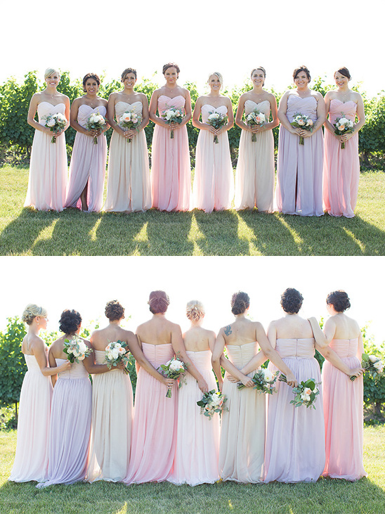 Bridesmaids in pastel dresses holding bouquets in a sunny outdoor setting