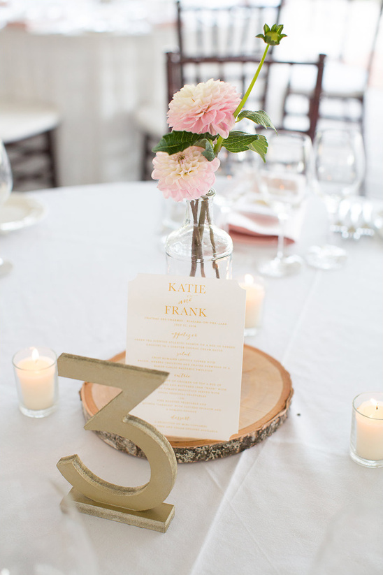 Wedding table setting with floral centerpiece and table number three