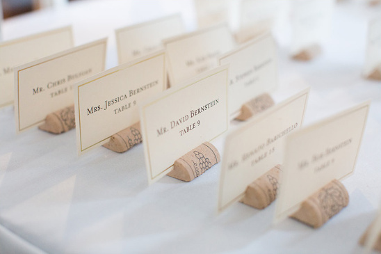 Elegant place cards held by wine corks on a table setting