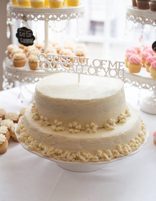 Elegant wedding cake with Cause All of Me Loves All of You topper