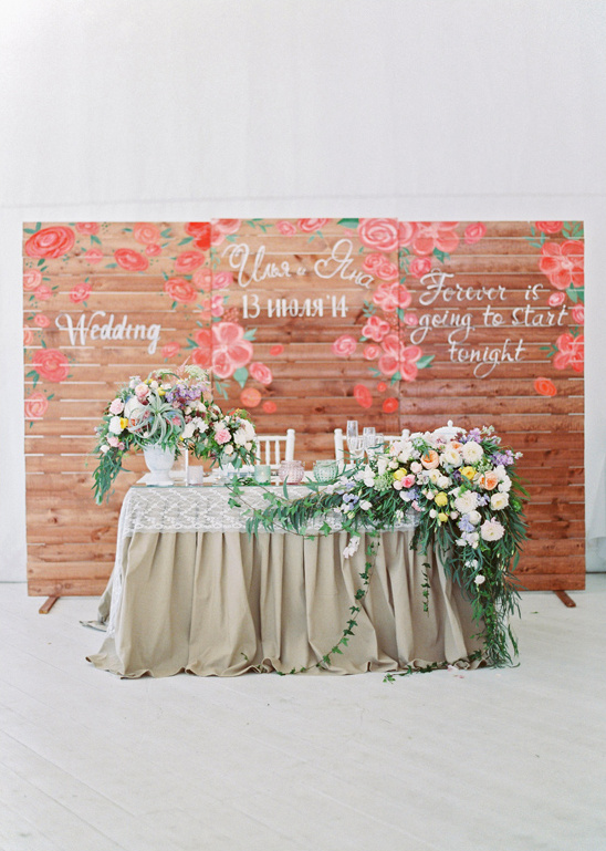 sweetheart table with wood pallet backdrop