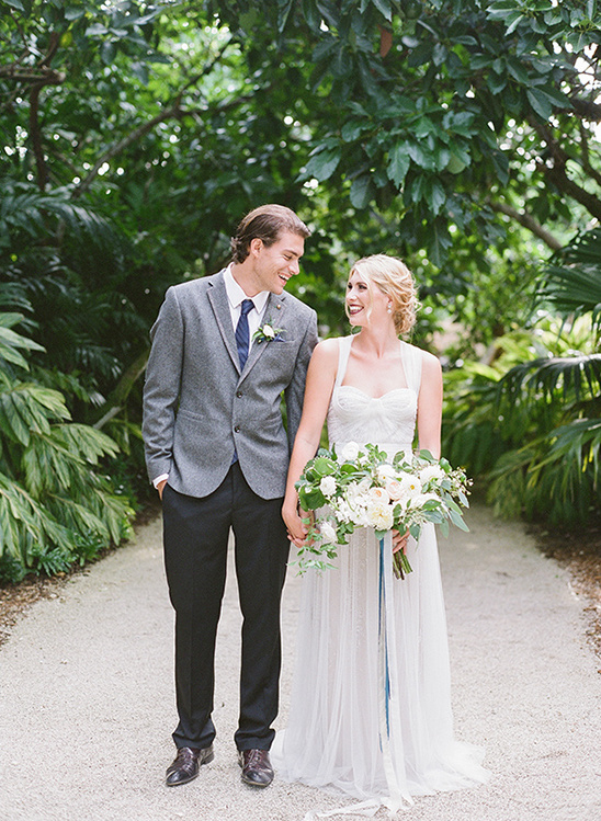 Happy couple holding hands on a wedding day, smiling at each other