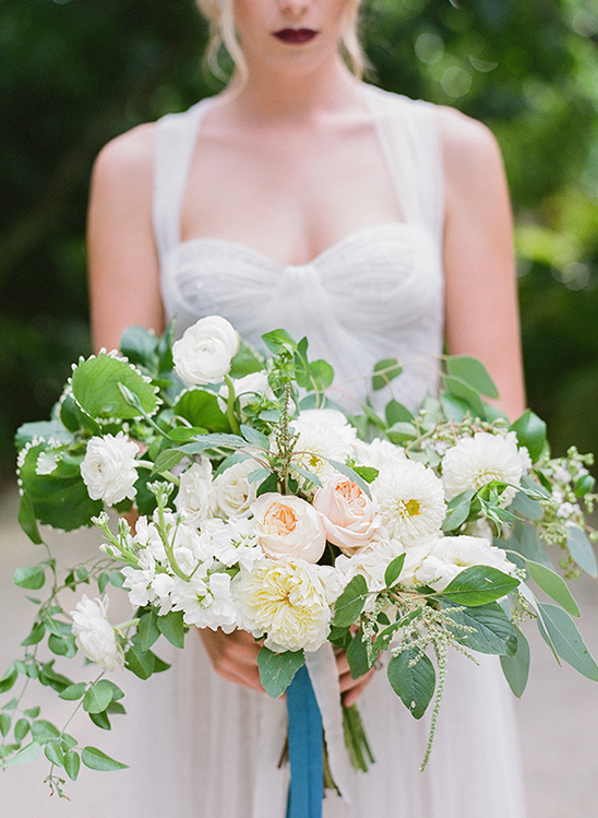Bride holding elegant bouquet with white and blush flowers