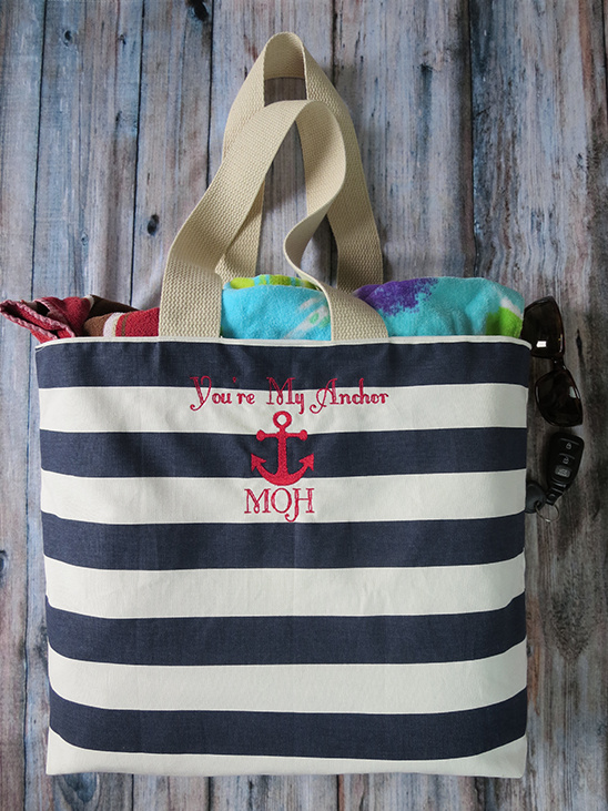 Navy and white striped beach tote with towels and sunglasses