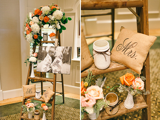 Rustic wedding decor with ladder display, flowers, and photo
