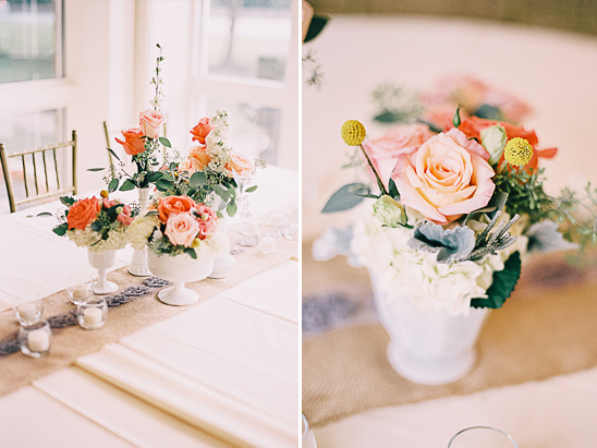 Floral centerpieces with peach roses and greenery on a table