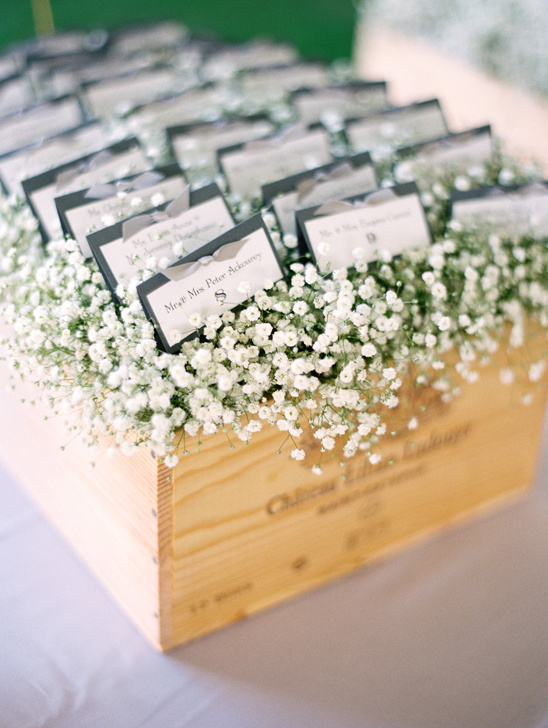 escort cards nestled in a box of babys breath