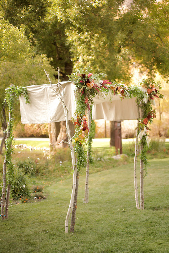 rustic flower covered wedding arch
