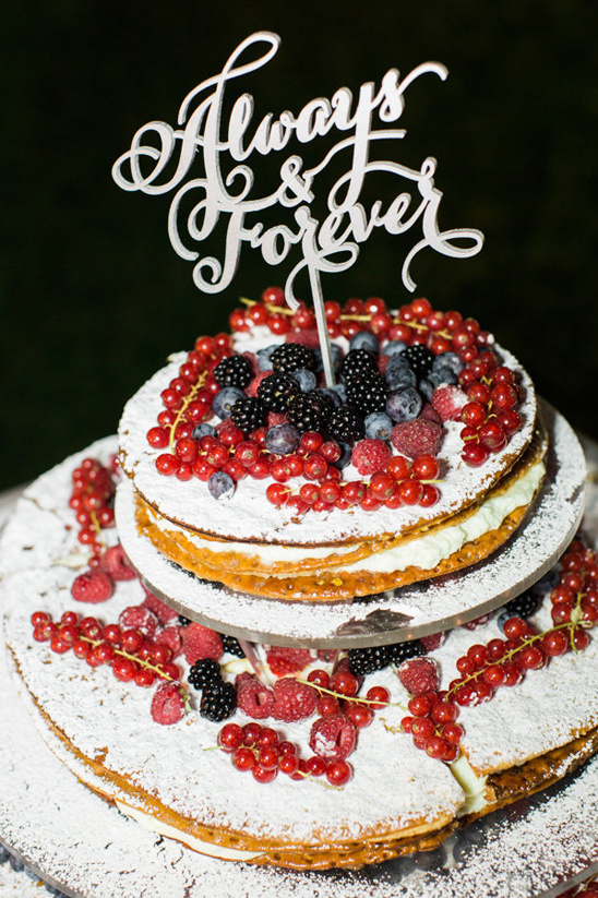thin layered wedding cake topped with fresh berries