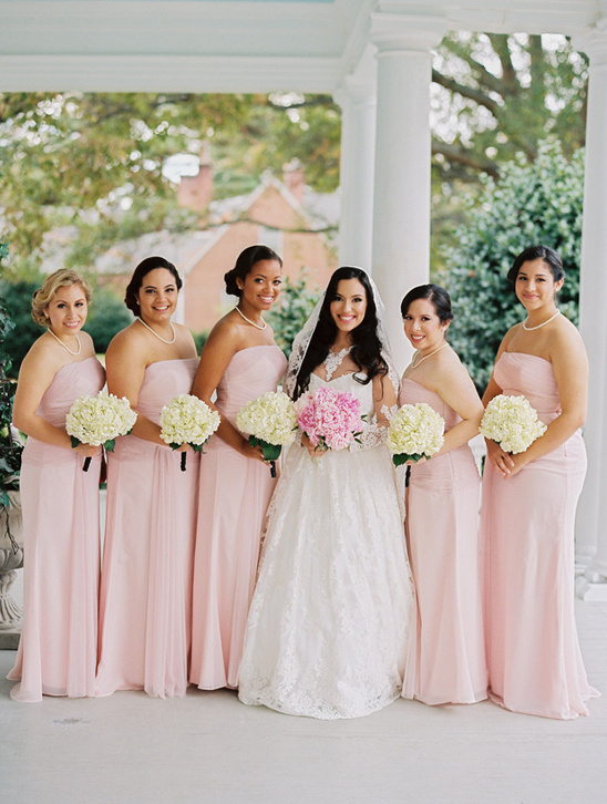 Bride and bridesmaids in pink dresses at a wedding ceremony