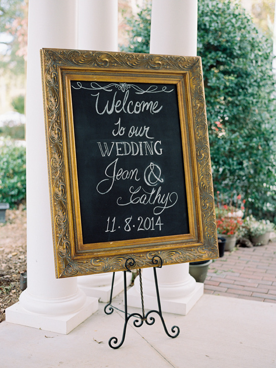 Wedding welcome sign with gold frame and calligraphy lettering