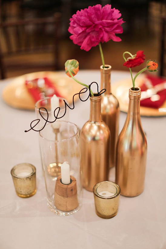 gold bottles with wire table numbers @weddingchicks