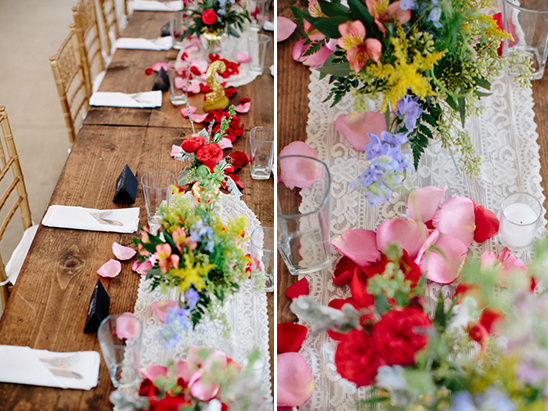 Wedding table centerpiece with colorful flowers and petals
