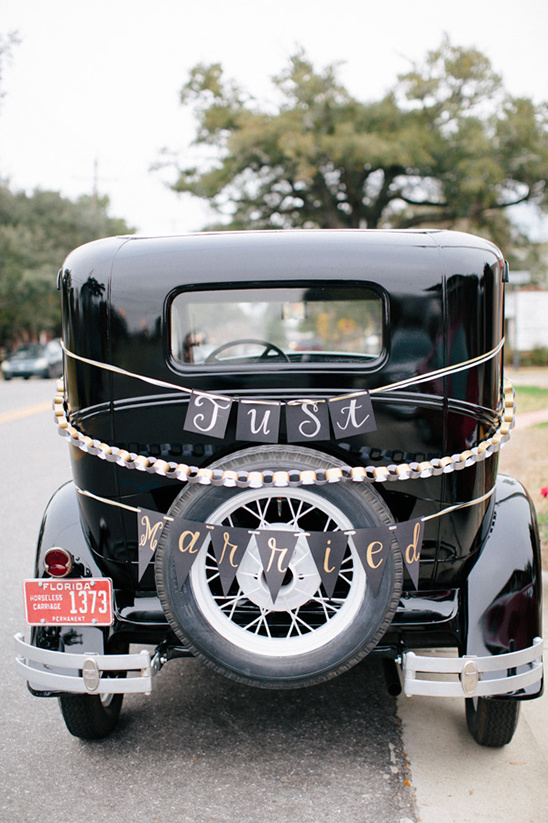 Classic wedding car with just married banner and decor