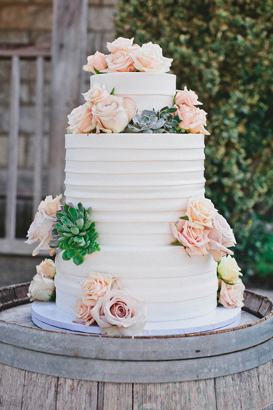 rose and succulent topped wedding cake @weddingchicks