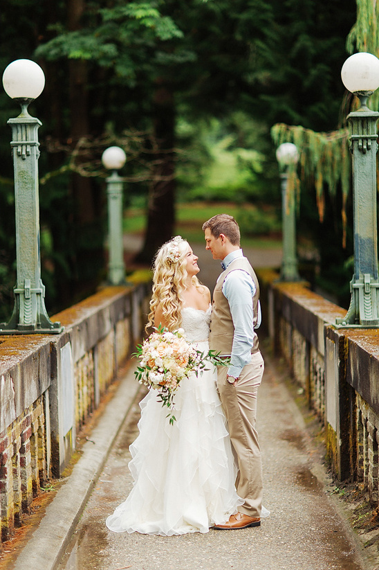Romantic couple on a bridge during their wedding day