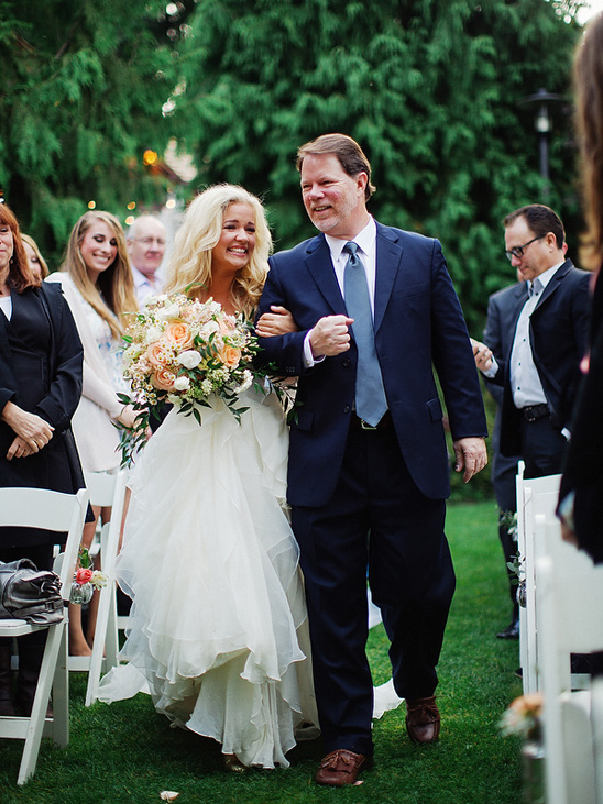 Bride walks down the aisle with her father, wedding day