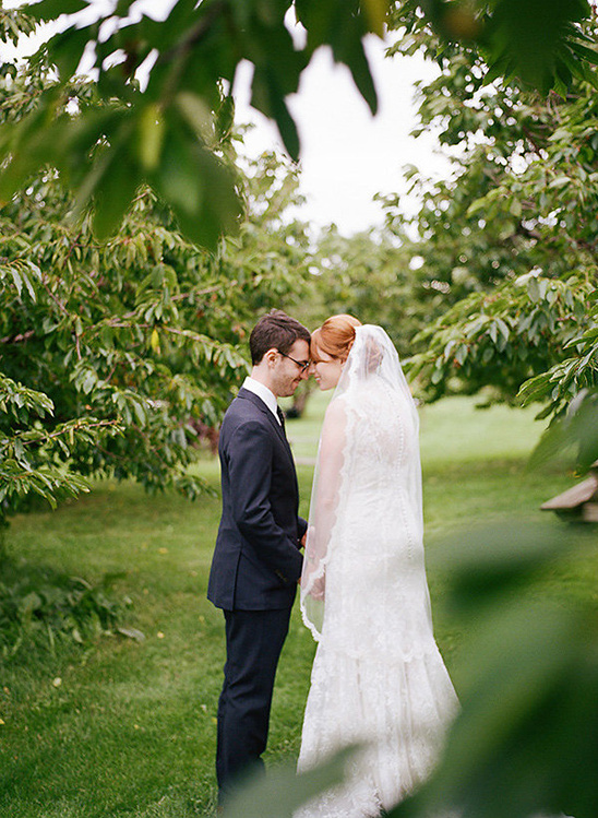 Romantic wedding couple in the park under the green trees