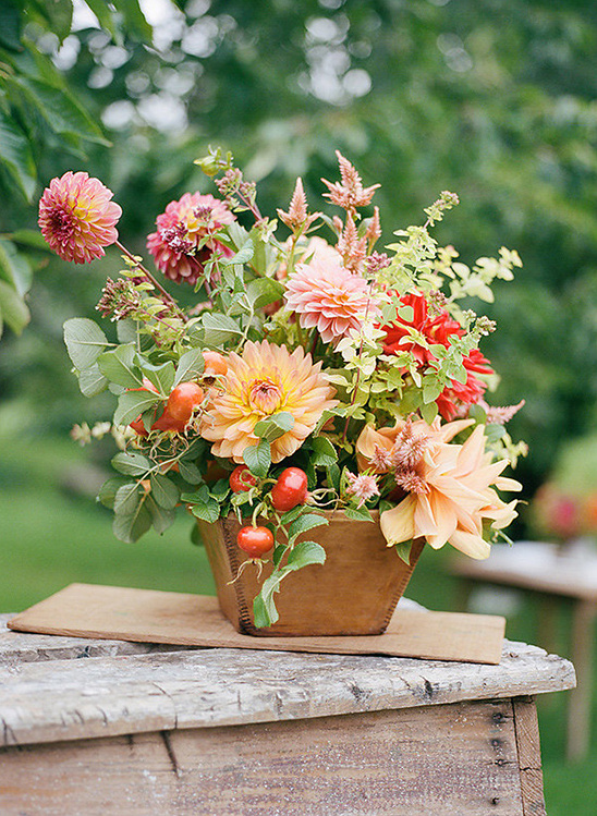 A beautiful arrangement of dahlias and other flowers in a wooden box