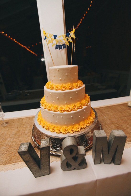 mini bunting topped wedding cake @weddingchicks
