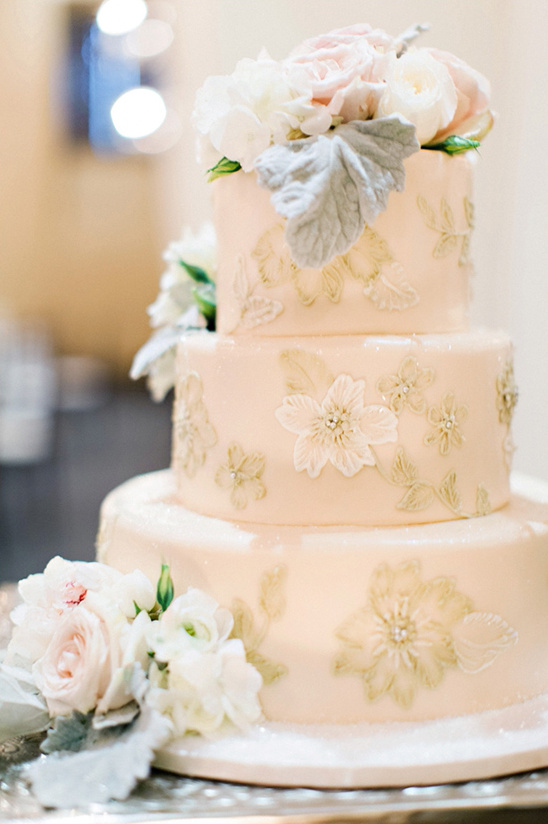 blush wedding cake with floral decor