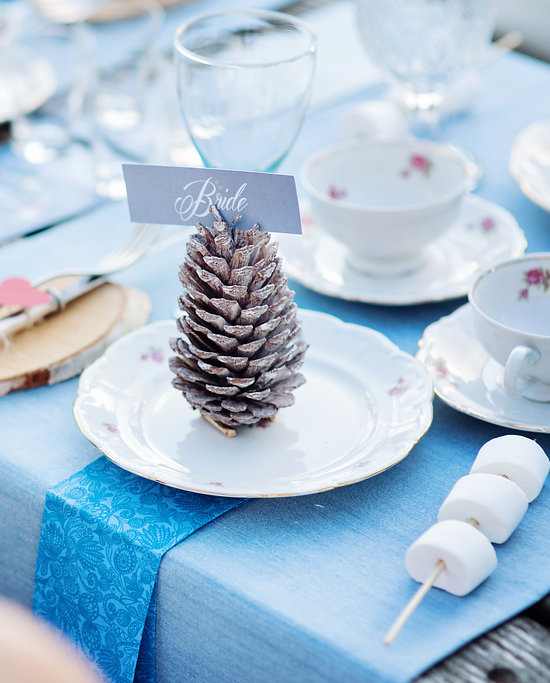 Wedding table setting with pinecone place card holder