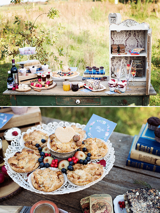 Rustic dessert table set outdoors with pies and treats