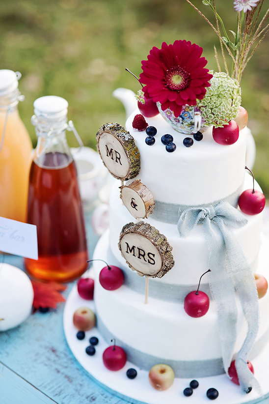 Rustic wedding cake with Mr & Mrs wooden sign and fruits