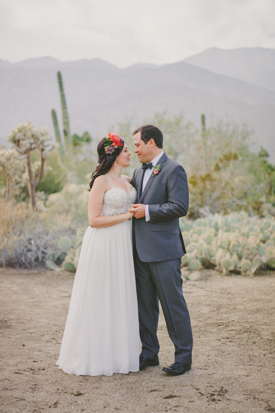 Happy couple embrace on their wedding day in the desert setting