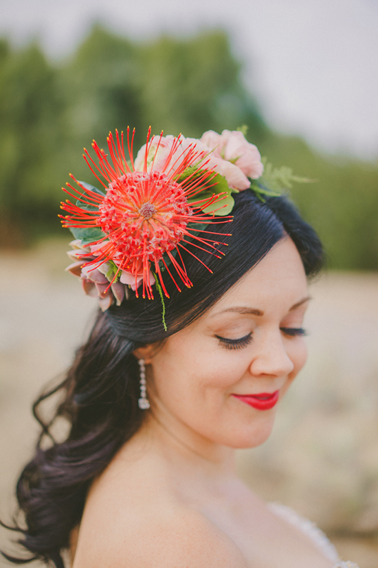 Bride with a vibrant flower crown, smiling with closed eyes