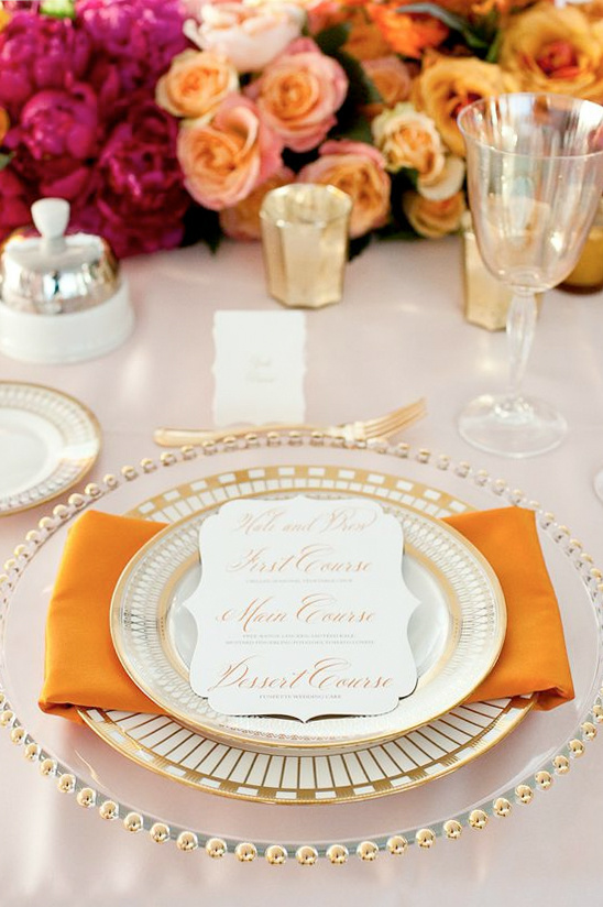 Elegant wedding table setting with vibrant floral arrangements