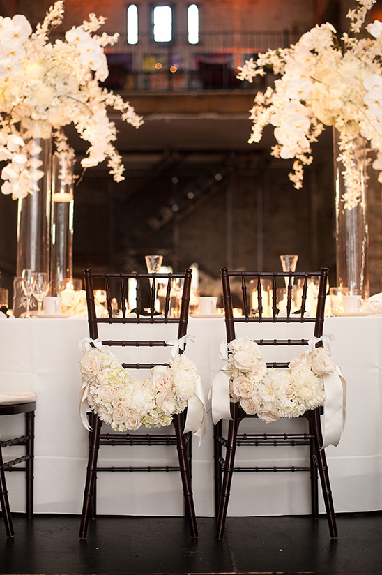 Elegant wedding reception chairs with floral decorations