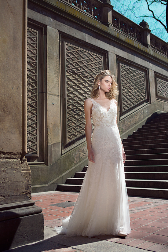 Elegant bride in lace wedding dress, standing outdoors