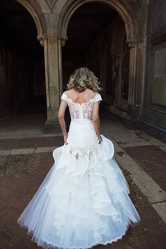 Bride in elegant wedding dress walking in a tunnel