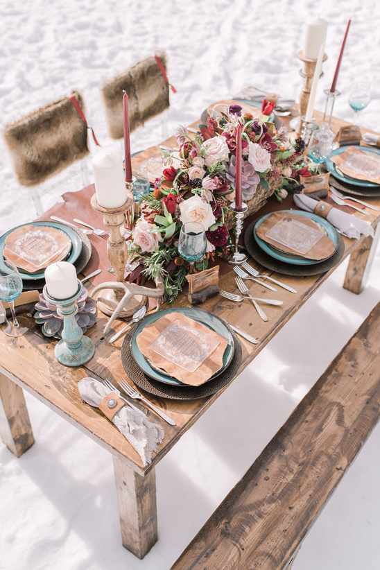 Rustic outdoor wedding table setting with floral centerpiece