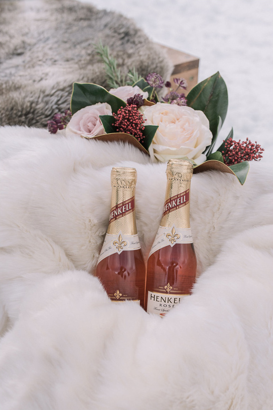 Two bottles of Henkell Rose with flowers on faux fur