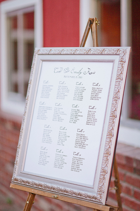 Elegant wedding seating chart displayed on an easel outside