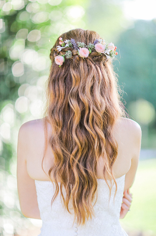 Bride wearing a flower crown and a strapless dress, wedding hairstyle