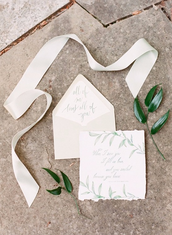 Elegant wedding invitation with calligraphy and ribbon detail