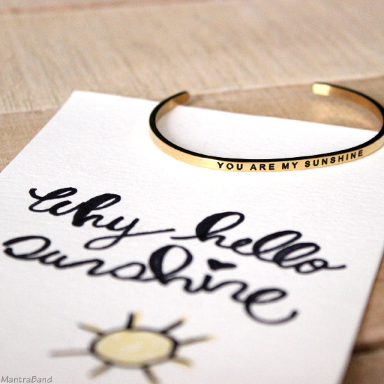 Golden bracelet with the words You are my sunshine on a card