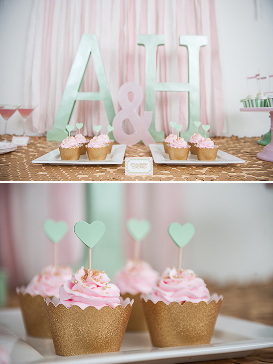 Strawberry cupcakes with heart toppers at a wedding party
